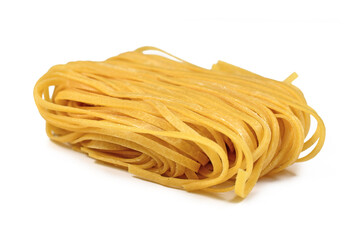 Unooked italian 'Tagliolini' noodles, a long ribbon pasta similar to spaghetti isolated on white background