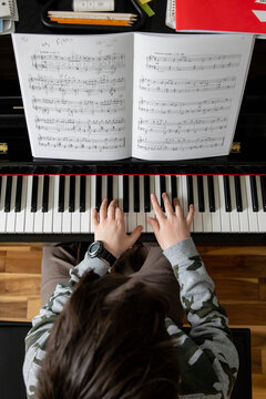Boy Practising Piano Overhead View