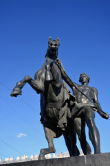 Obraz premium Horse tamers monument by Peter Klodt on Anichkov Bridge in Saint-Petersburg Russia. 