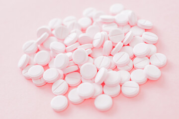 Fototapeta na wymiar Pink pills on a pink background. Medical pharmacy concept