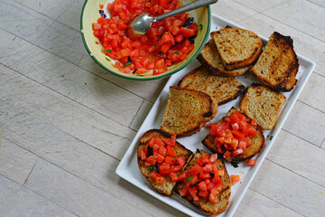 A platter of tomato bruschetta toasts
