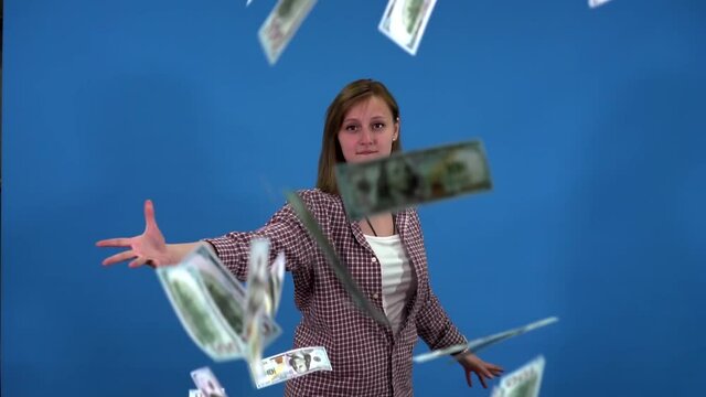 girl throws a pack of dollars at the camera