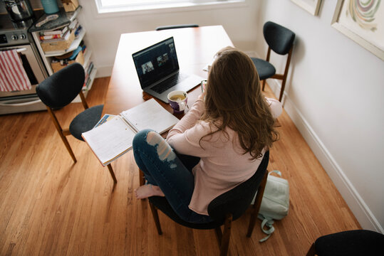 High Angle View Of Teenage Girl E Learning On Laptop At Home