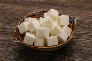 Refined white sugar cubs in the bowl
