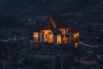 Morning In Biertan, Old Transylvania,One Of Most Famous Four Ancient Fortification Churches Of Romania.Blue Hour.Pastel-Coloured Houses With Dilapidated Tiled Roofs Surround The Citadel. - 360296328