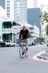 African American man riding his bike in the city street
