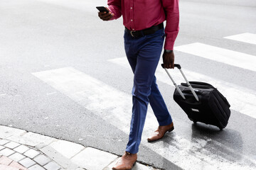 African American man on the go crossing the street