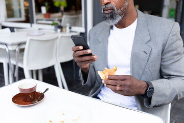 African American man spending time at a coffee terrace