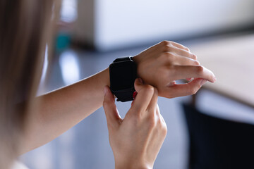Focus on digital watch wearing by a woman 