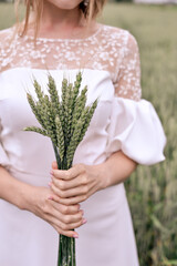 Lady (bride) in white dress holding  wheatgrass