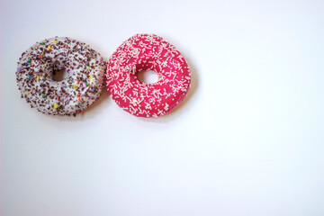 Colorful donuts on white background. Group of glazed donuts isolated on white background. Top view of beautiful donuts, space for text.