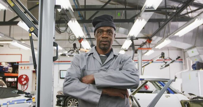 African American male car mechanic crossing his arms and looking at camera