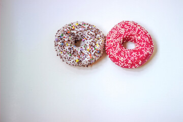 Colorful donuts on white background. Group of glazed donuts isolated on white background. Top view of beautiful donuts, space for text.