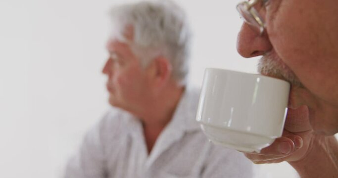 Close Up Of A Caucasian Senior Man Sitting At A Table With His Male Friend Together Socialising Befo