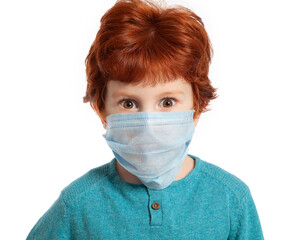 A beautiful European red-haired boy of 5 years in a mask against coronavirus. The masked child's...