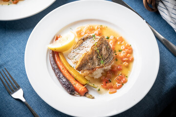 sea bass poele with white wine sauce, luxury restaurant style dish