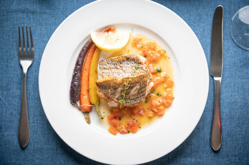 sea bass poele with white wine sauce, luxury restaurant style dish