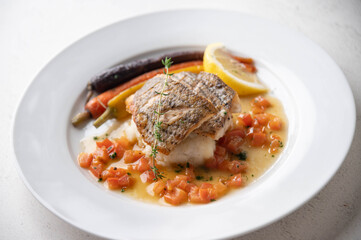 sea bass poele with white wine sauce, luxury restaurant style dish