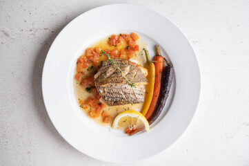 sea bass poele with white wine sauce, luxury restaurant style dish