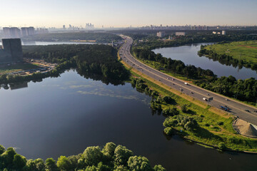 panoramic view of expressway across the river taken from a drone at dawn
