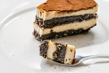 Vegan Dessert Tiramisu Bite on Fork with Date Fruit Paste, Cashew Cream, Coconut Milk and Espresso.