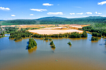 Obraz premium Aerial view of dumps and polluted ponds. Gold mining. Problem of environmental pollution