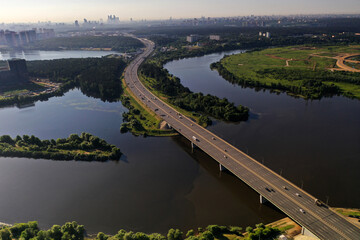 panoramic view of expressway across the river taken from a drone at dawn