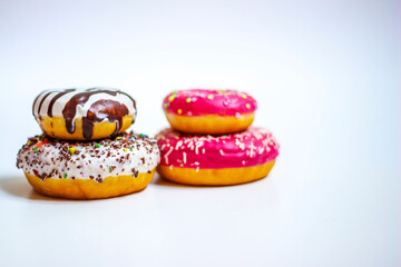 Doughnut with frosting. Dessert colorful snack. Glazed sprinkles. Sweet icing sugar food on white background. Close up.