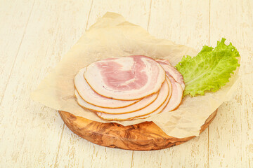 Sliced Pancetta sausage over board