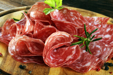 thinly sliced salami, delicious snack rustic salami on table