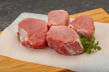 Raw pork medallion served rosemary