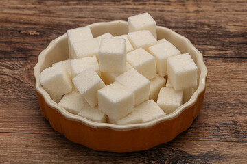 Refined white sugar cubs in the bowl