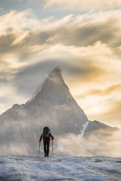Backpacker hiking towards Mt. Loki, Baffin Island, Canada.