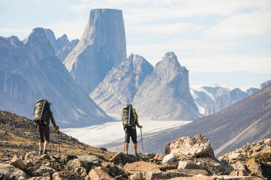 Rear view of backpackers approaching Mount Asgard, Akshayak Pass.