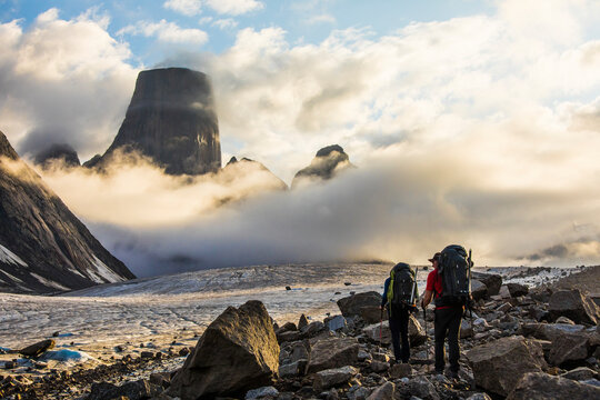 Two backpackers hiking towards Mount Asgard, Baffin Island.