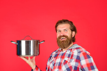 Man with saucepan. Happy chef with cooking pot. Saucepan. Cooking. Kitchenware. Cooking utensils. Cooking vessels. Kitchen advertising.