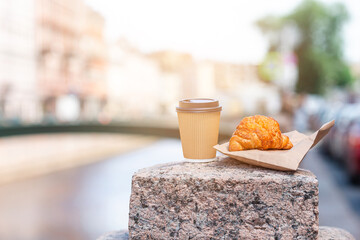 Traditional breakfast of coffee and fresh croissant outdoors
