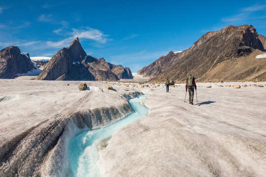 Rear view of climbers approaching Mt. Loki, Baffin Island, Canada.