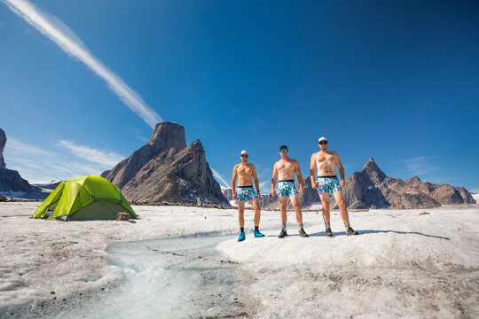 Three mounatineers wearing only popsicle underwear stand on glacier.