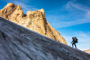 Mountaineer climbs glacier on approach to Mount Asgard.