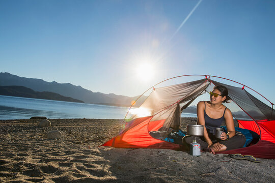 Woman relaxing at camp at the Nahuel Huapi Lake in Patagonia