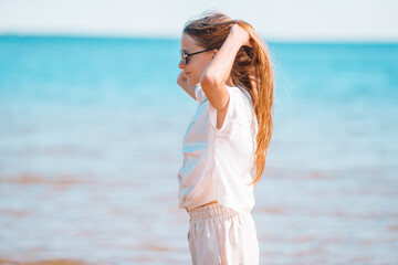 Adorable little girl at beach during summer vacation