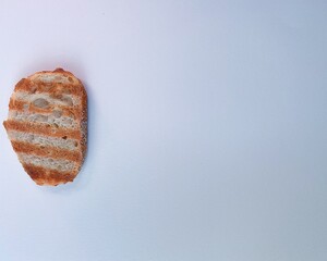 fresh, fragrant, striped toasted grill lies on a white background, morning, breakfast, free space for text, under the inscription, cutout, copy space, texture, close-up. High quality photo horizontal