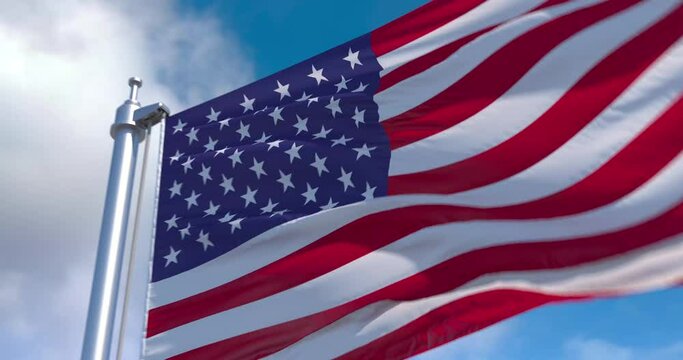 USA flag on a flagpole waving in the wind in the sky. Wonderful intro for yor projects. Great for stories, presentations with texts and corporate projects.