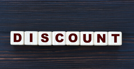 concept word DISCOUNT on cubes on a beautiful dark wooden background