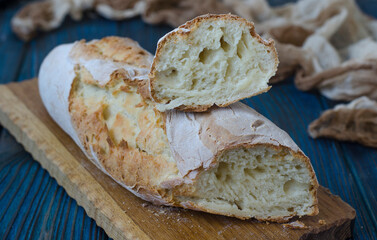Crispy baguette with cracks on the board