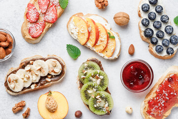 Sweet sandwiches with fruits and berries on white background.