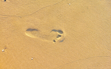 Footprint on the beach with fine golden sand of the Mediterranean sea