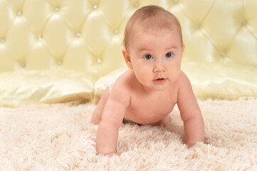 Portrait of cute little baby girl on bed