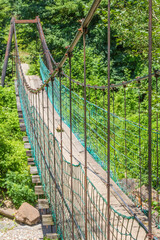 Picturesque suspension bridge on a mountain river